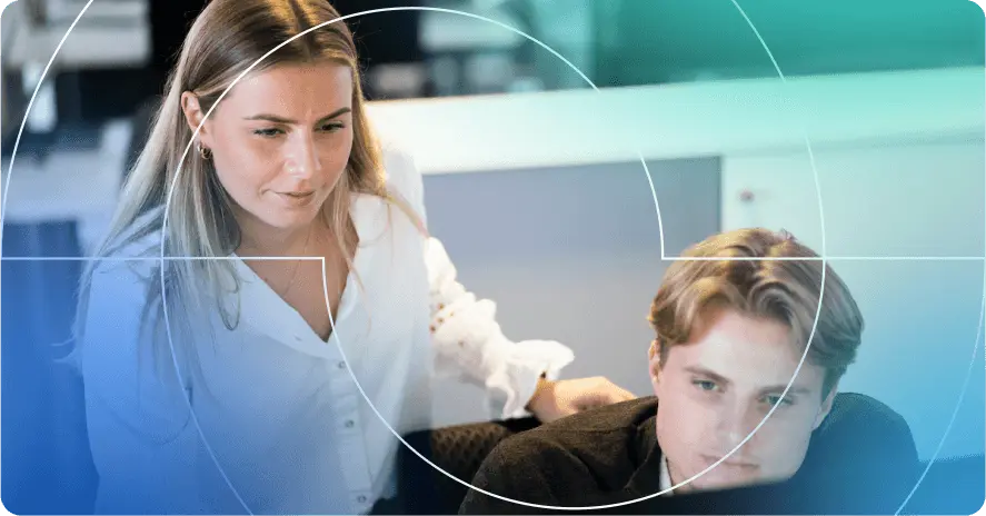 two colleagues looking at computer screen