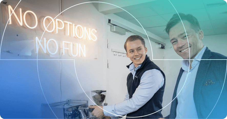 two colleagues smiling in front of no options no fun sign